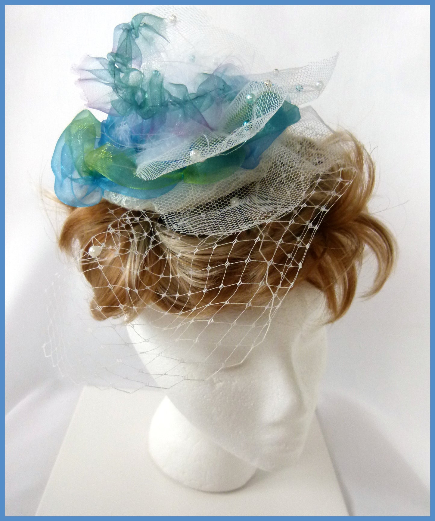 Ocean Blue Fascinator with beaded blue/green organza and white net and veiling